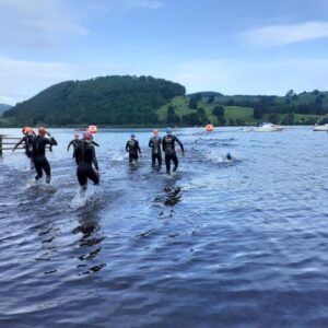 Triathletes entering the lake