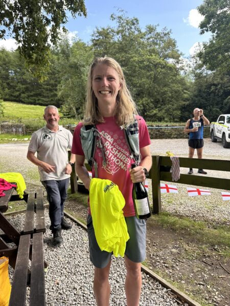 Gillian Allen with a bottle of wine having won a race