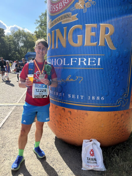 Sam Ainscough stood next to a giant inflatable beer bottle that is only partly in shot