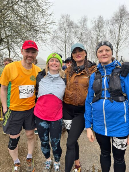 Four runners posing before a race