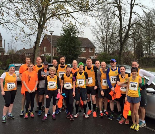 Steel City Striders in race kit posing for a pre-race photo