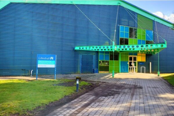 A large warehouse-style building, primarily blue. A sign saying "Lilleshall" is in front of it