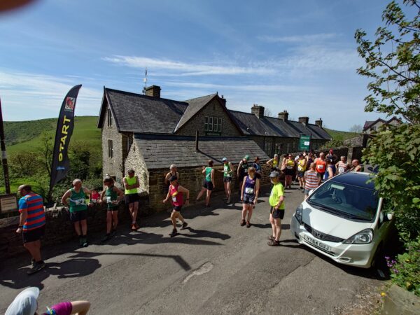 Runners warm up in front of the Cressbrook club before the Cressbrook Crawl race