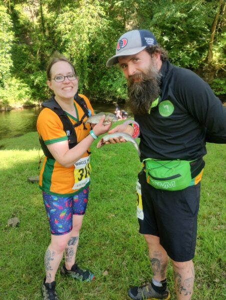 Jim and Laura holding a fish each