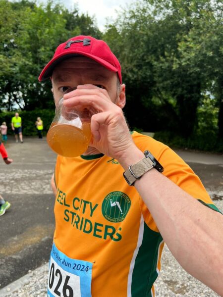 Matt Broadhead downing a pint of beer from a plastic